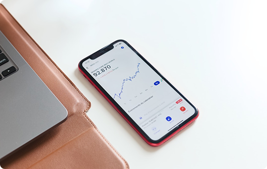 Phone on desk with stocks on the phone